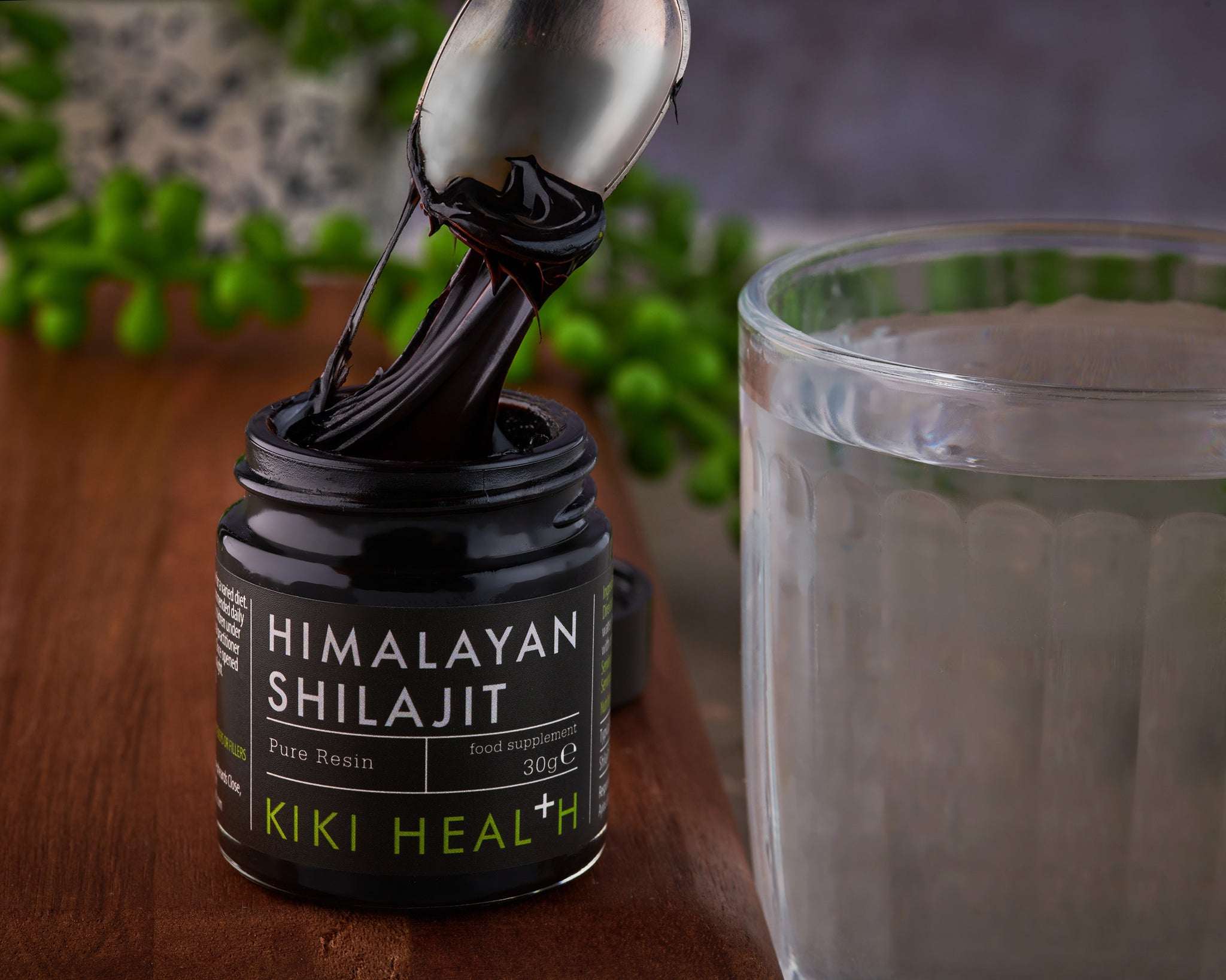 Jar of Himalayan Shilajit resin being scooped with a spoon